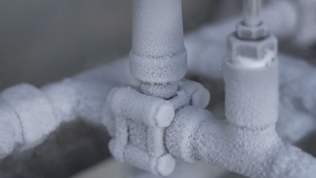 A pipe joint covered in frost
